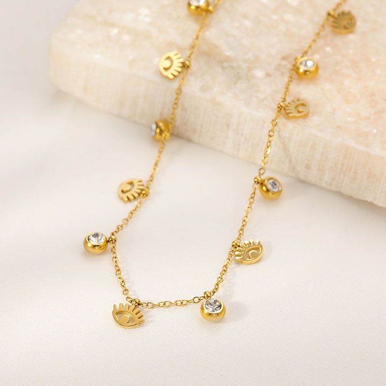 金 ネックレス 目元モチーフと輝石のチャーム付き華奢チェーンネックレス