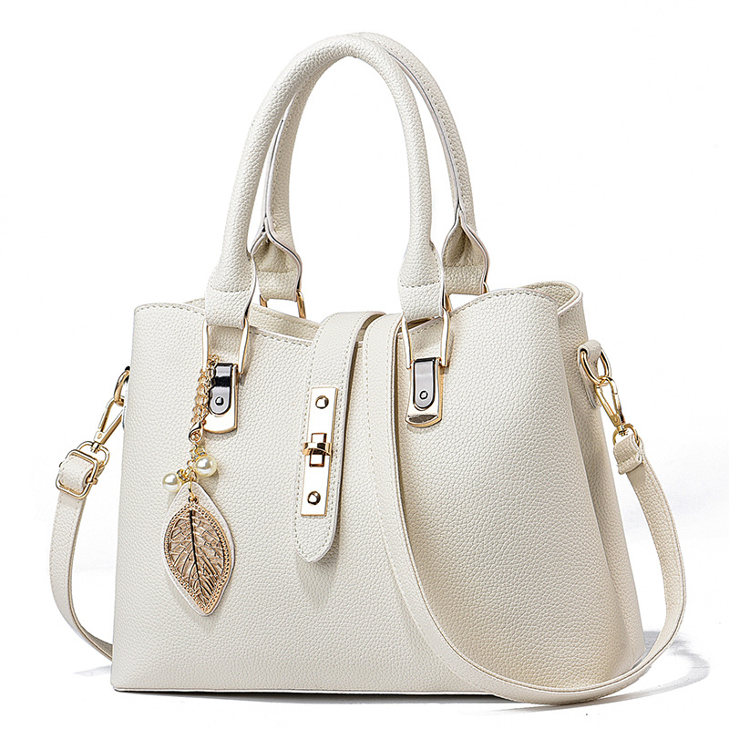 革バッグレディース 葉型チャーム付き上品な二重取っ手革バッグ